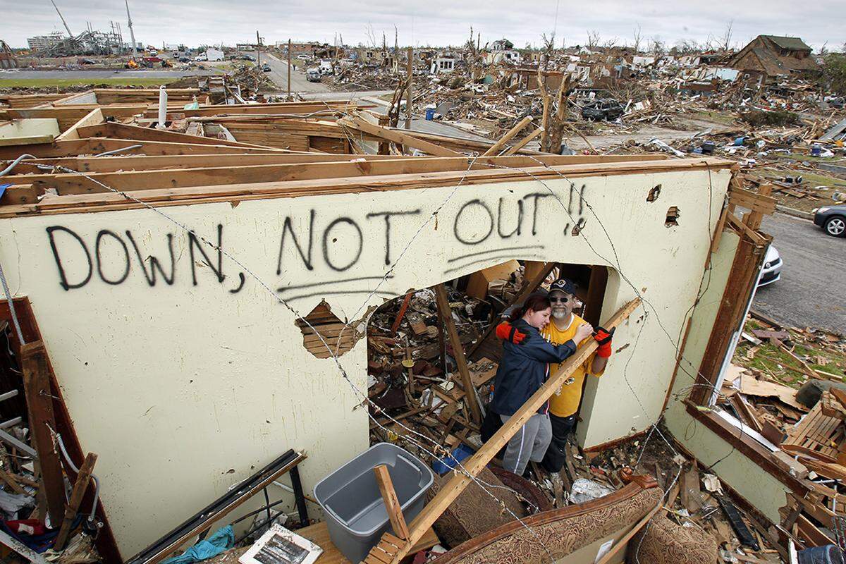 Saying that they like the community and the good people, Tim and Stacey Bartow are planning to stay in Joplin. The survived the tornado by taking shelter in their basement along with a neighboring family. They were at the home on Thursday, May 26, 2011, to locate belongings. Speaking about the hand painted sign, Tim said “I wanted to get the message out there that there’s hope.” 05252011 KEITH MYERS/The Kansas City Star
