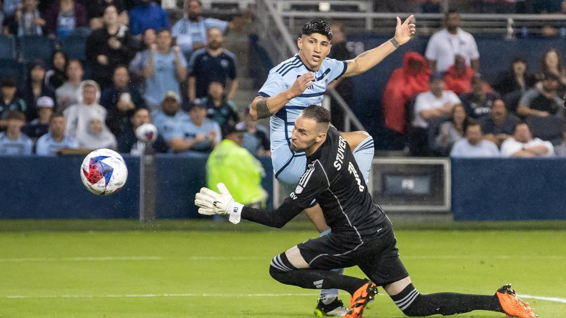 Sporting Kansas City forward Alán Pulido (at rear in photo)scores his second goal of the night against Austin FC goalkeeper Brad Stuver during Saturday’s match at Children’s Mercy Park in Kansas City, Kansas.