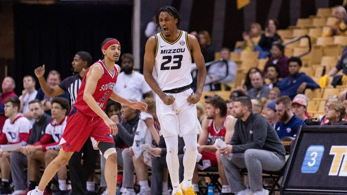 Missouri’s Aidan Shaw, right, celebrates a three-pointer in front of Southern Indiana’s Trevor Lakes during the first half of Monday night’s season opener in Columbia, Mo.