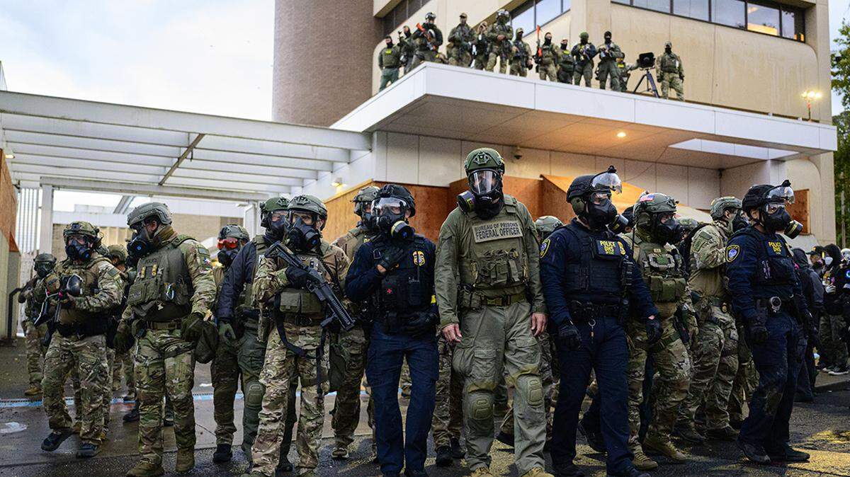 PORTLAND, OREGON - OCTOBER 12: Federal agents clash with anti-I.C.E. protesters at the U.S. Immigration and Customs Enforcement building on October 12, 2025 in Portland, Oregon. An Instagram post from the WorldNakedBikeRidePortland account stated - “The emergency WNBR Portland is in response to the militarization of our peaceful city. Right now peaceful protesters are being brutalized as they do their best for our neighbors and cousins who are being kidnapped.” (Photo by Mathieu Lewis-Rolland/Getty Images)