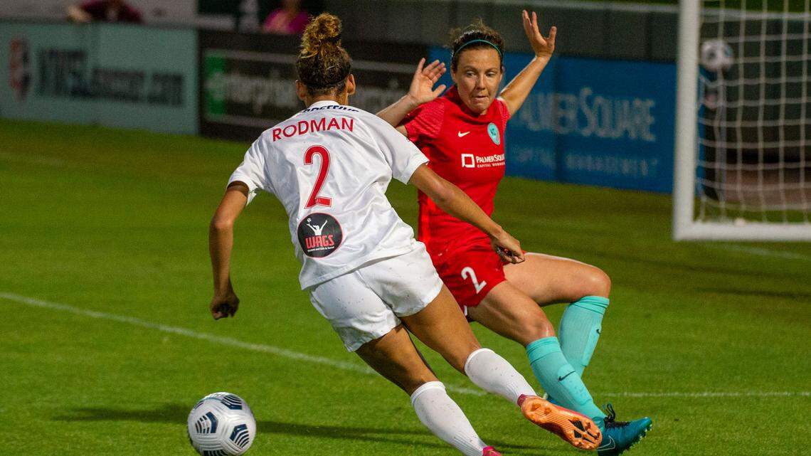 Washington Spirit Trinity Rodman passes Kansas City defender Rachel Corsie to score during the second half of the game, Saturday, June 26, 2021, at Legends Field in Kansas City, Kan. Rodman put Washington ahead to win the game 2-1
