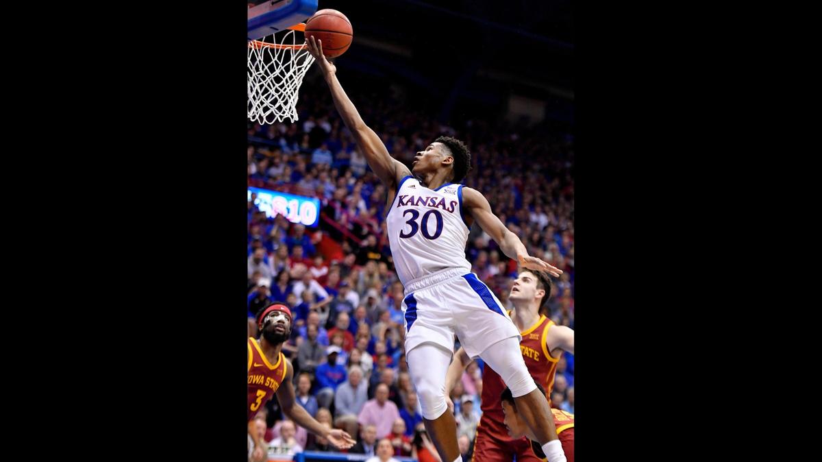 KU’s Ochai Agbaji blows by ISU’s Michael Jacobson for a bucket during the first half of a game against the Cyclones.