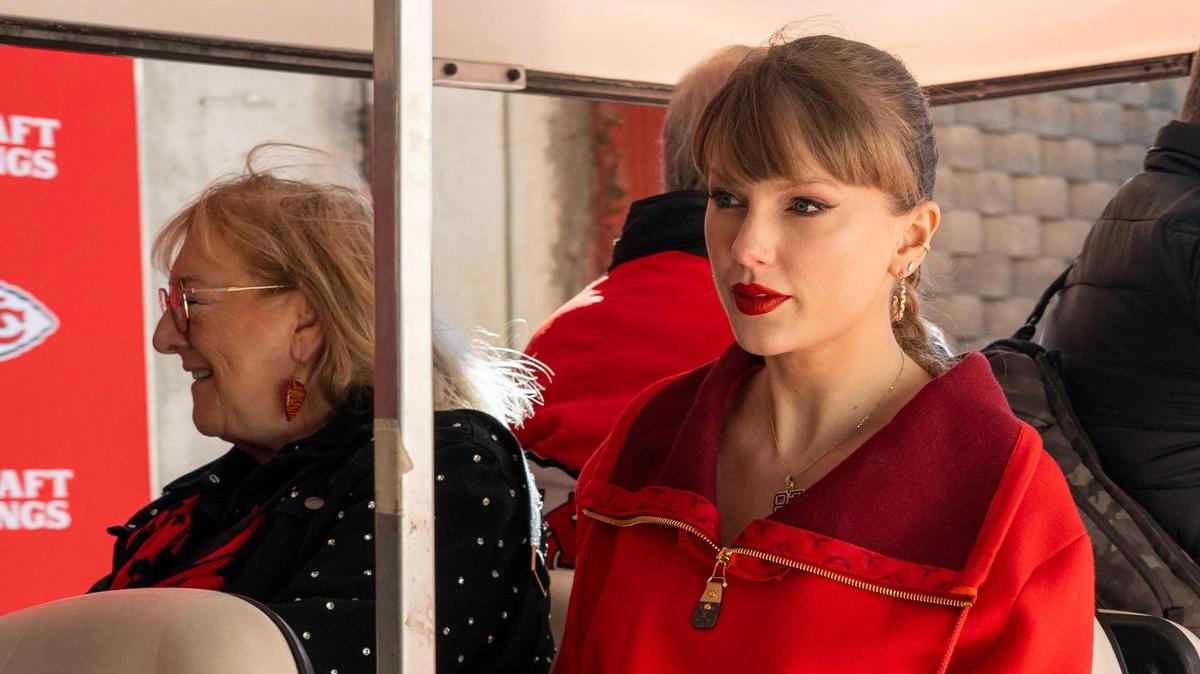 Donna Kelce, left, and pop star Taylor Swift are driven through the tunnel on a golf cart to attend the Kansas City Chiefs’ game against the Las Vegas Raiders on Friday, Nov. 29, 2024, at GEHA Field at Arrowhead Stadium.