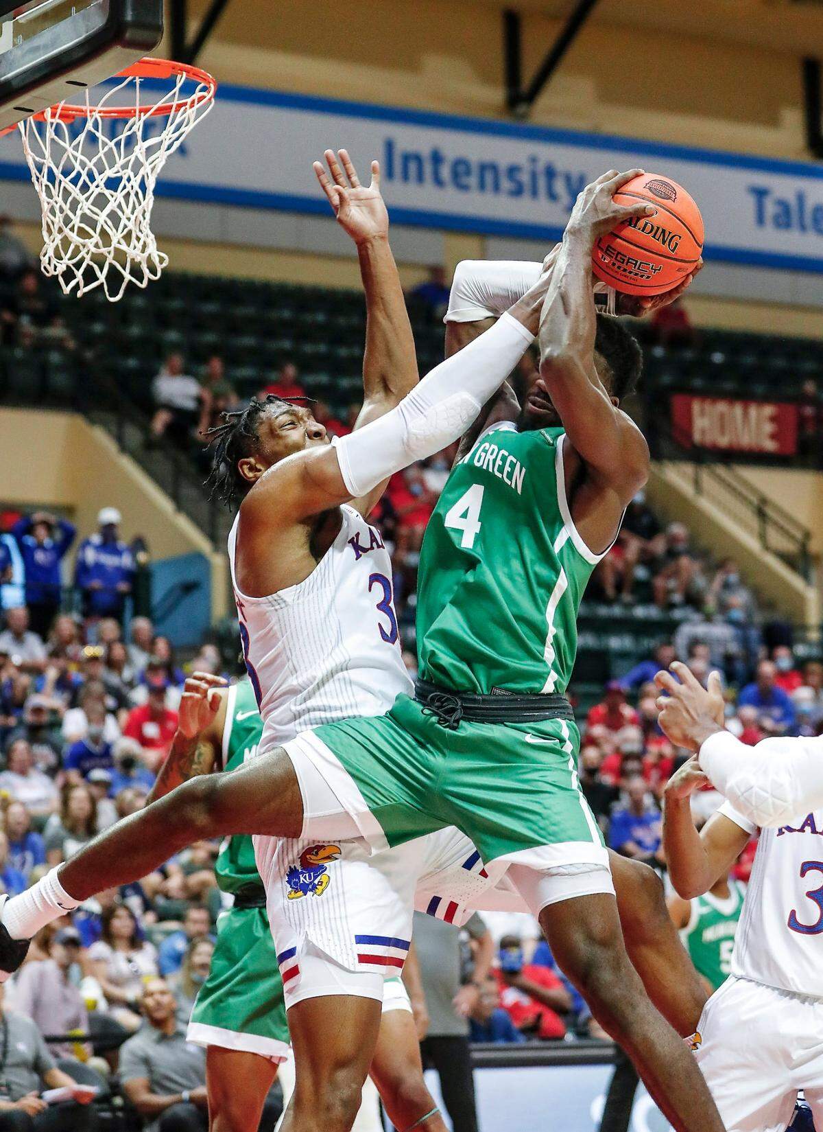 Kansas forward David McCormack, left, blocks a shot by North Texas forward Thomas Bell during Thursday’s game in Kissimmee, Fla.