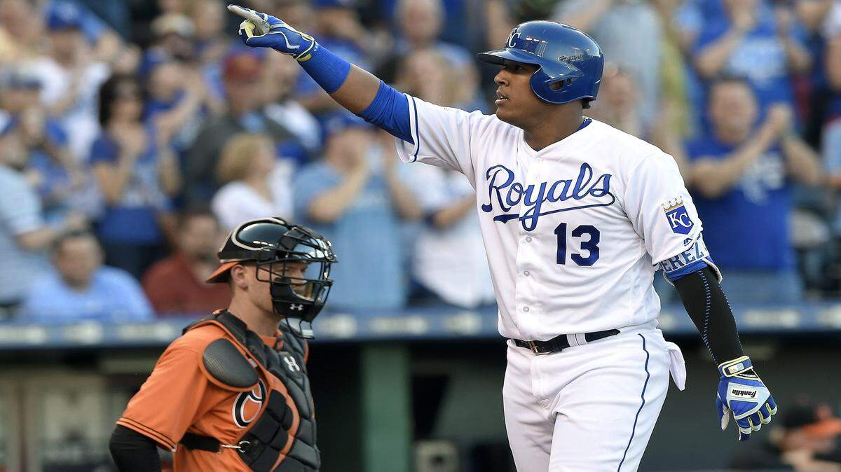Kansas City Royals' Salvador Perez celebrates his two run home run in front of Baltimore Orioles catcher Matt Wieters in the second inning during Saturday's baseball game on April 23, 2016 at Kauffman Stadium in Kansas City, Mo.