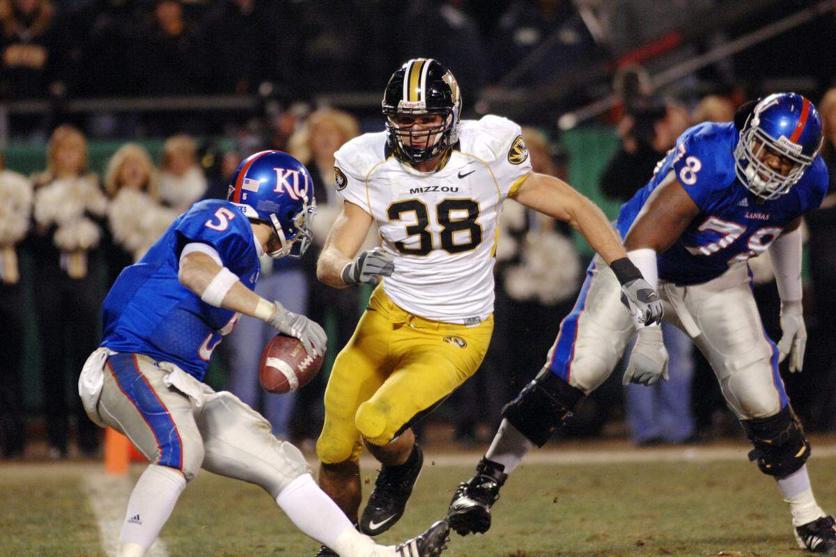 Missouri defensive lineman Stryker Sulak (38) comes in for the sack on Kansas quarterback Todd Reesing (5) in the fourth quarter as the Tigers defeat the Jayhawks 36-28 at Arrowhead Stadium on Nov. 24, 2007.