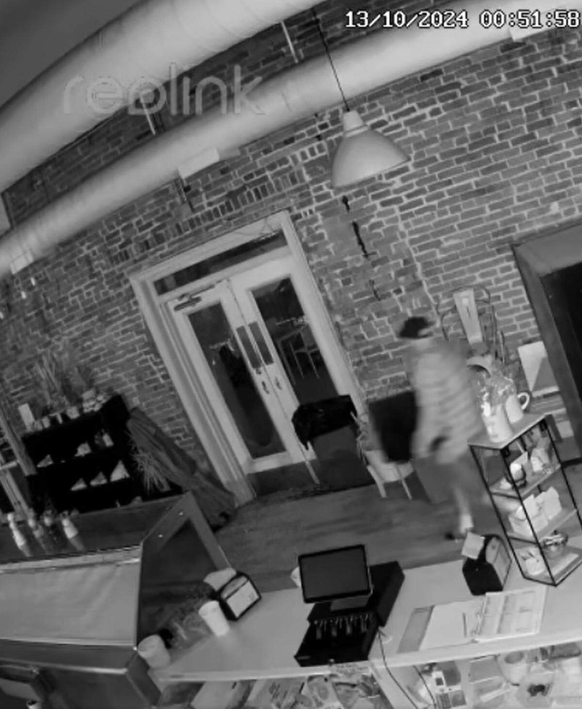 A screenshot of surveillance video showing a burglar leaving the Betty Rae’s Ice Cream shop in the River Market with a safe early Sunday morning during a break-in.