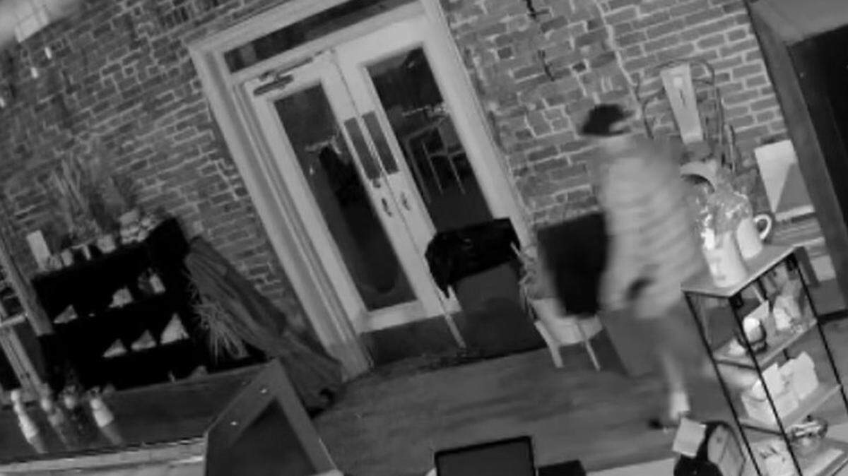 A screenshot of surveillance video showing a burglar leaving the Betty Rae’s Ice Cream shop in the River Market with a safe early Sunday morning during a break-in.