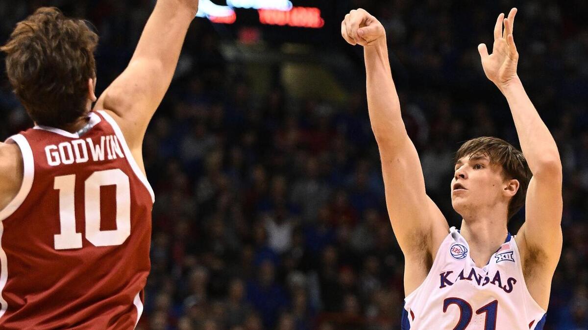 KU’s Zach Clemence sinks a three-pointer over OU’s Sam Godwin during the first half of a Big 12 Conference game at Allen Fieldhouse on Jan. 10, 2023.