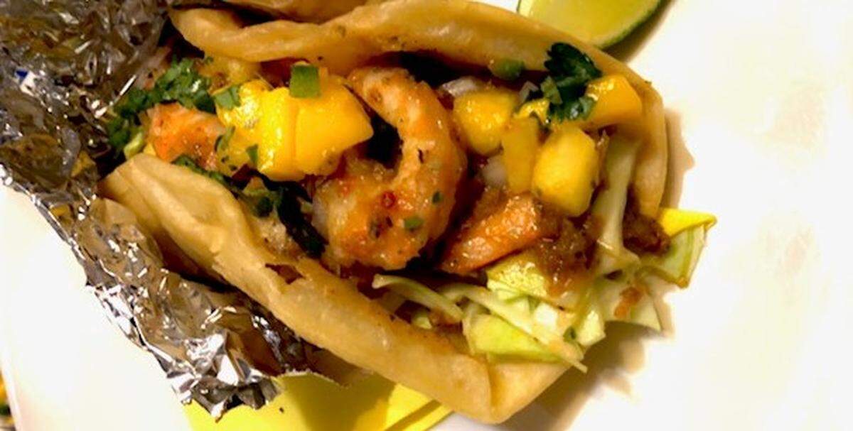 A Taste taco with a jerk shrimp and its signature pineapple and mango salsa.
