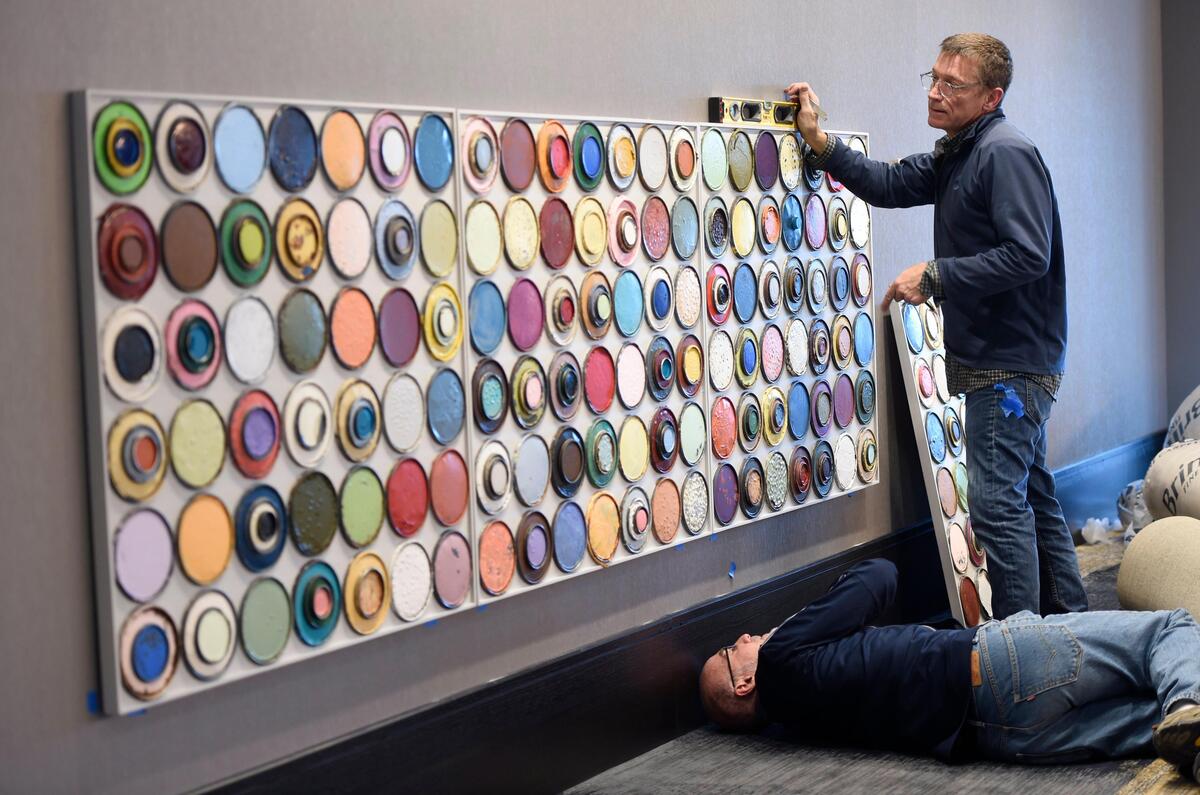 Alex Kremske, below, and Paul Churchill of Monarch Fine Art Services installed artwork Wednesday at the new Loews Kansas City Convention Center Hotel.