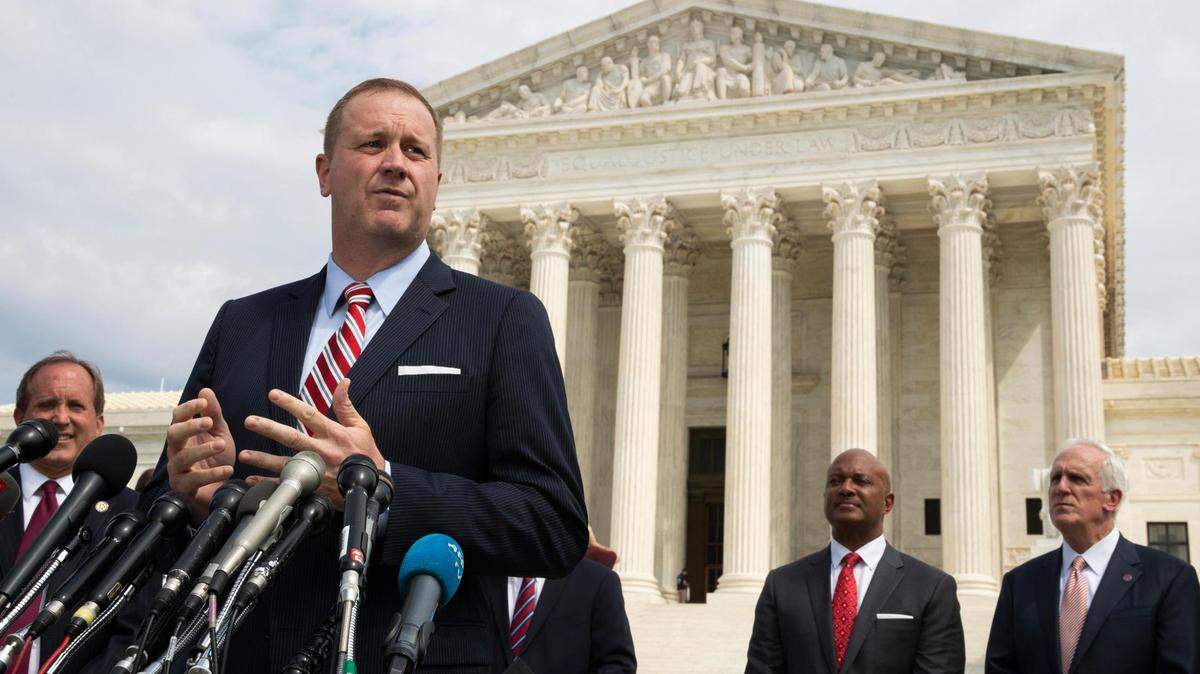 In this Sept. 9, 2019, file photo, Missouri Attorney General Eric Schmitt speaks in front of the U.S. Supreme Court in Washington. Schmitt on Tuesday, April 21, 2020, filed a lawsuit against the Chinese government, the Community Party of China and others, alleging that the hiding of information and other actions at the outset of the coronavirus outbreak led to loss of life and significant economic damage in Missouri.