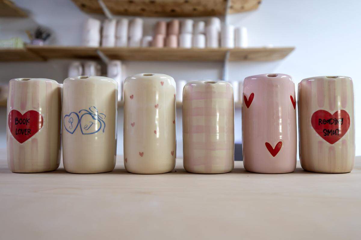 Valentine's Day-themed to-go ceramic cups made by ceramicist Priscilla Butler are displayed on a table at her studio, Lila's Clayground, on Thursday, Jan. 29, 2026, in Kansas City.