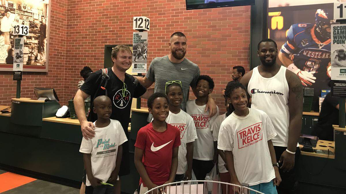 Travis Kelce, Kansas City Chiefs tight end, stands with some of the 10 kids that received $150 gift cards Saturday at Dick's Sporting Goods.