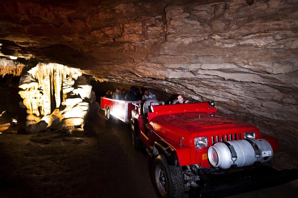 Tour guide Heather Stanley ducks as she drives visitors on a 55-minute tour of Fantastic Caverns in Springfield. The attraction offers the only cave tour in North America that’s all riding, no walking.