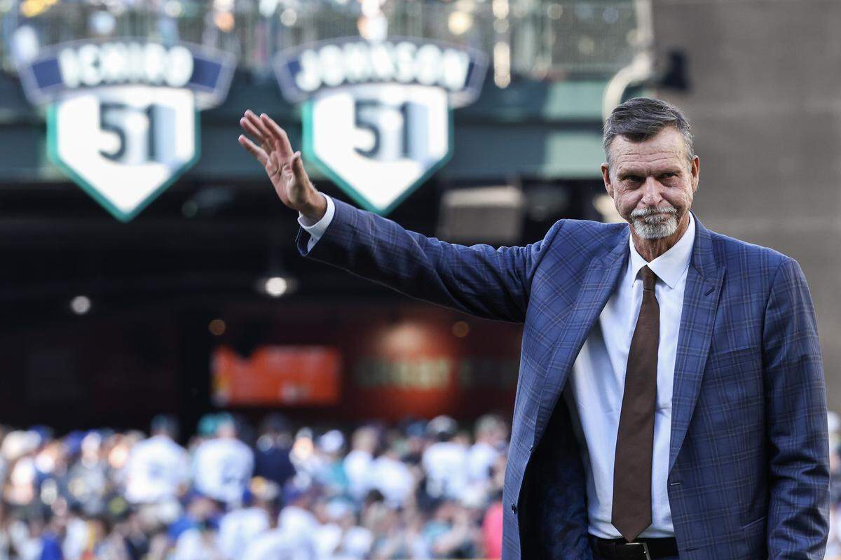 Former Seattle Mariners star pitcher and baseball Hall of Famer Randy Johnson waves during a ceremony at which his number was officially retired ahead of a Saturday, May 2, 2026 game between the Mariners and Kansas City Royals at T-Mobile Park in Seattle.