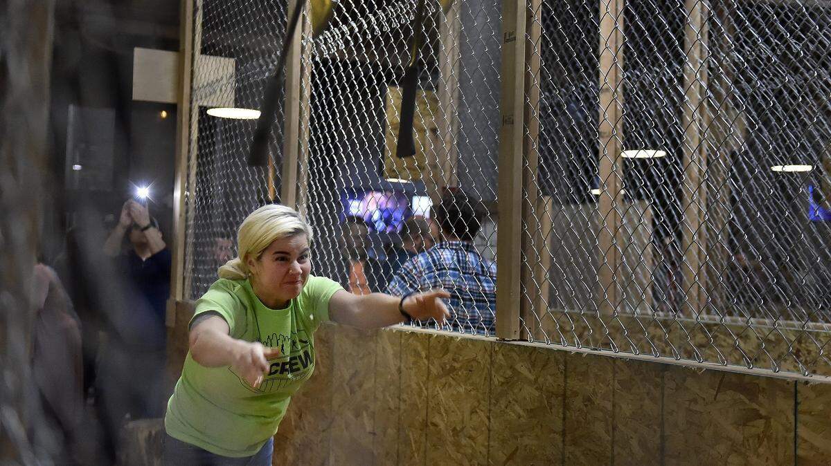 Blade & Timber, located in the West Bottoms, is a place where people can experience urban ax throwing. Molly O'Donnell of Kansas City does a trick shot, throwing two at the same time.