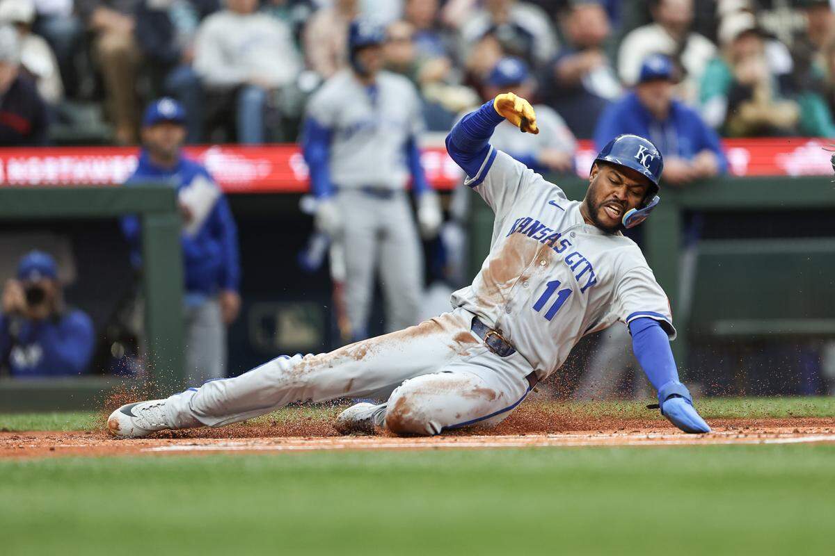 Royals third baseman Maikel Garcia slides across home plate to score in the first inning against the Mariners at T-Mobile Park in Seattle on Friday, May 1, 2026.