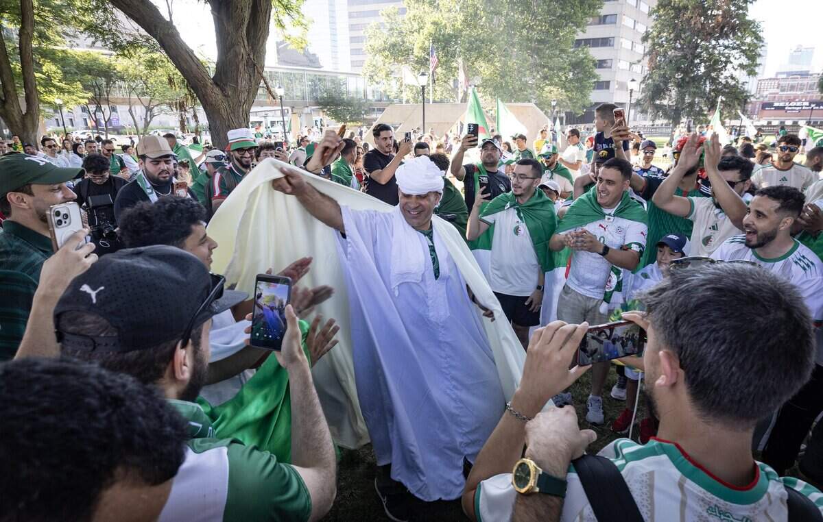 Algerian fans rally at Washington Park near Union Station the night before their team takes on defending World Cup champ Argentina at Kansas City Stadium.
