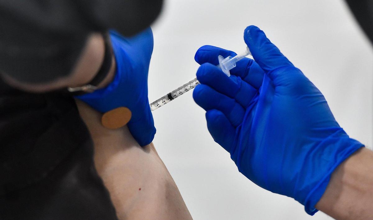 A woman receives a COVID-19 vaccine dose at the Platte County Health Department’s mass vaccination clinic which opened Tuesday, Mar. 2, 2021. The clinic is in an unused warehouse in the Horizons Industrial Park in Riverside donated by NorthPoint Development.