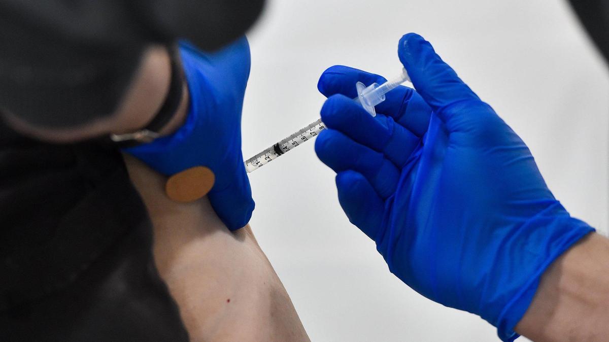 A woman receives a COVID-19 vaccine dose.