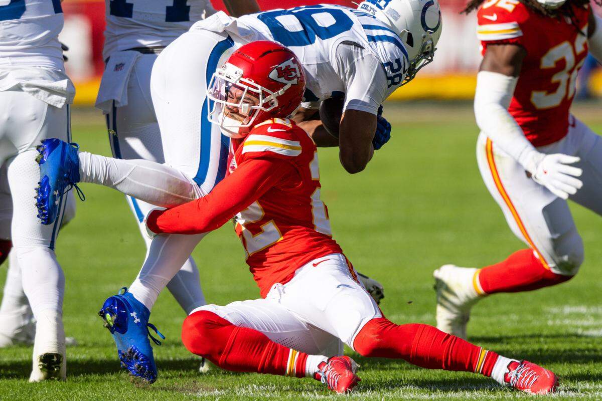 Kansas City Chiefs cornerback Trent McDuffie (22) makes a tackle on Indianapolis Colts running back Jonathan Taylor (28) during the first half of the Chiefs game against the Indianapolis Colts on Sunday, November 23, 2025, at GEHA Field at Arrowhead Stadium.