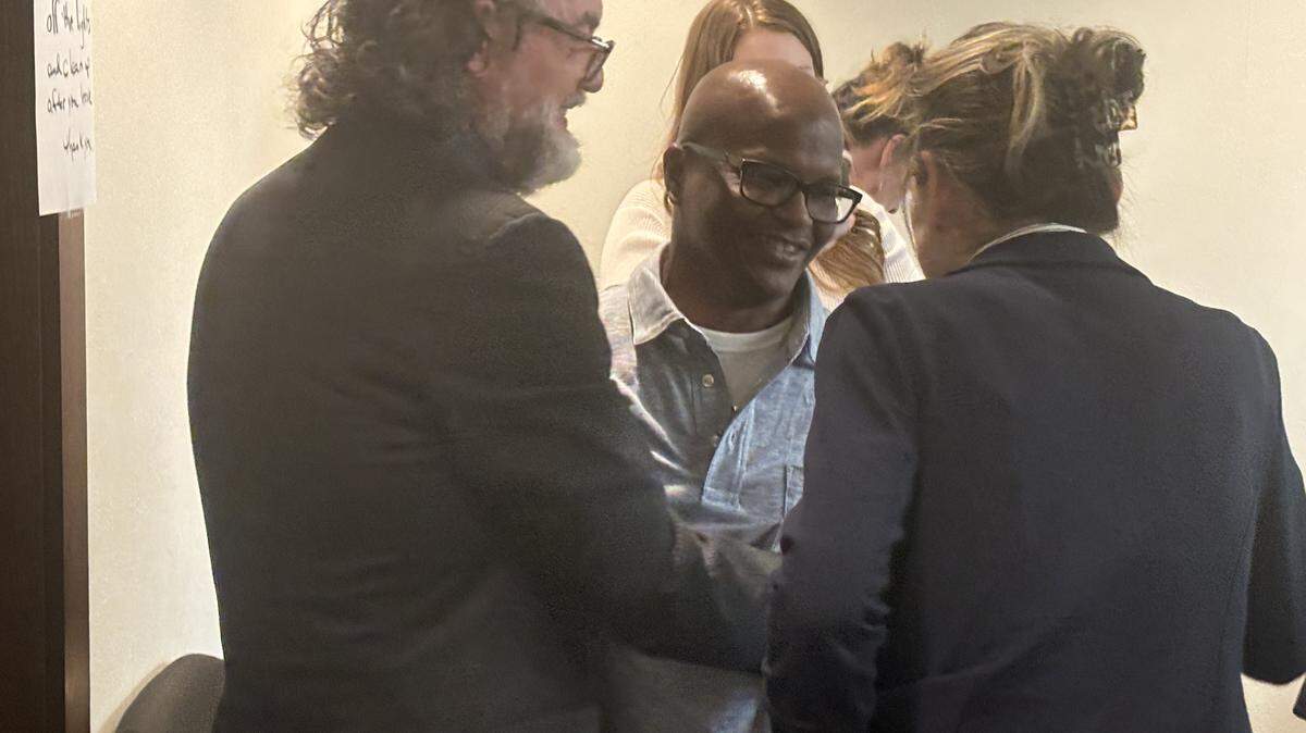 Celester McKinney, middle, hugs his attorneys following a judge ruling he received ineffective counsel in a 2022 hearing on a 1997 murder in Kansas City, Kansas with ties to former Det. Roger Golubski.