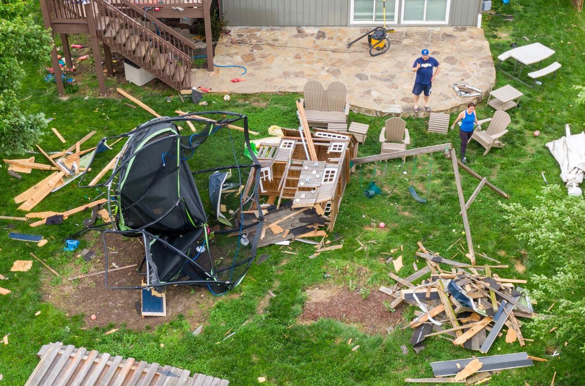 Kansas City area emergency management officials worry that staffing and budget cuts at the National Weather Service could impact safety during severe weather events. In this photo from May 2024, Herschel and Rebecca McWilliams cleaned up after a tornado hit near their home adjacent to Mill Valley High School in Shawnee, Kansas. The couple and their four children were home in bed when the storm hit.