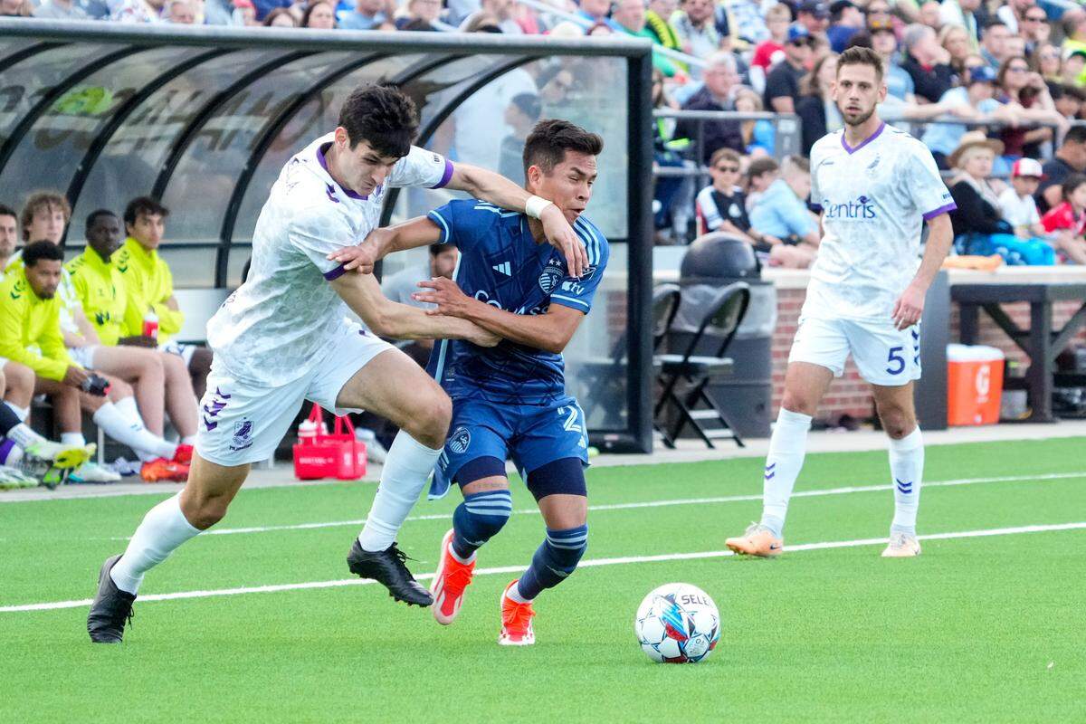 Union Omaha midfielder Pedro Dolabella, left, challenges Sporting Kansas City midfielder Felipe Hernández for possession during Wednesday evening’s Lamar Hunt U.S. Open Cup match at Caniglia Field in Omaha, Nebraska.