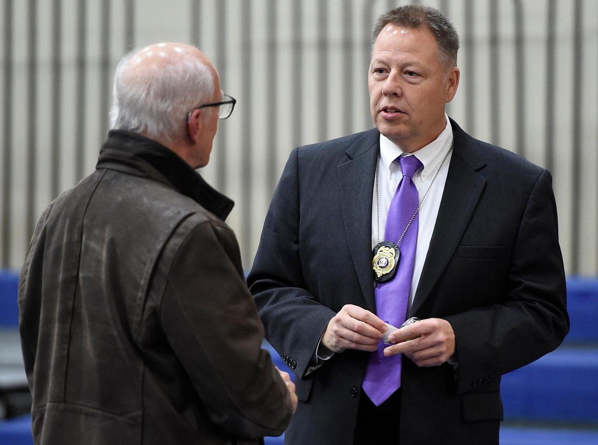 Before a meeting got underway at the South Patrol Station, Kansas City Police Chief Rick Smith, right, visited with a member of the community. Smith is being forced out as leader of the Kansas City Police Department.