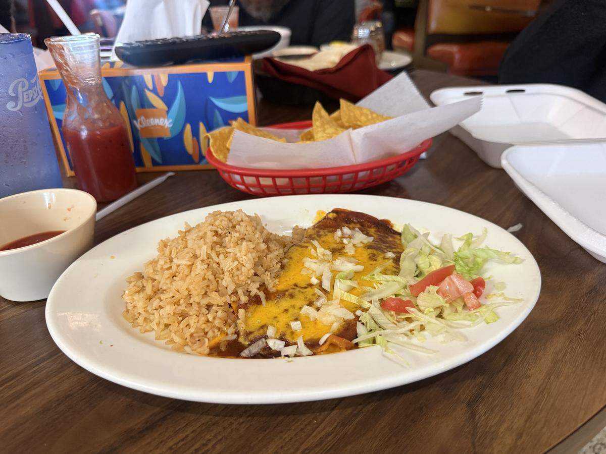 A cheese enchilada is served with rice and salad at Jalisco’s on May 6, shortly after the KCK restaurant announced its closure.