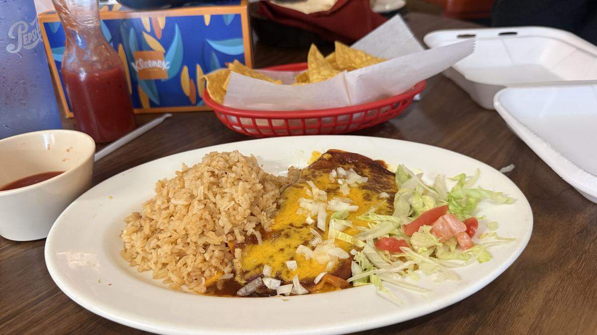 An enchilada is served with rice and salad at Jalisco’s on May 6, shortly after the KCK restaurant announced its closure.