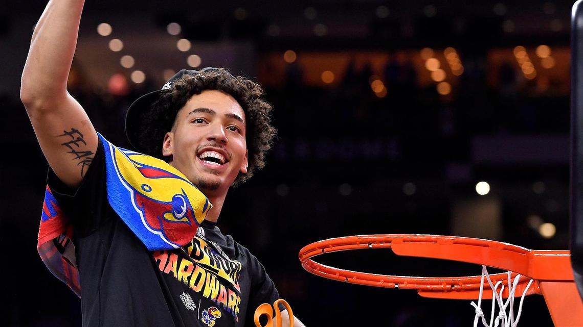 KU’s Jalen Wilson waves his cut of the net after the Jayhawks beat North Carolina Monday night in New Orleans to claim the NCAA title.