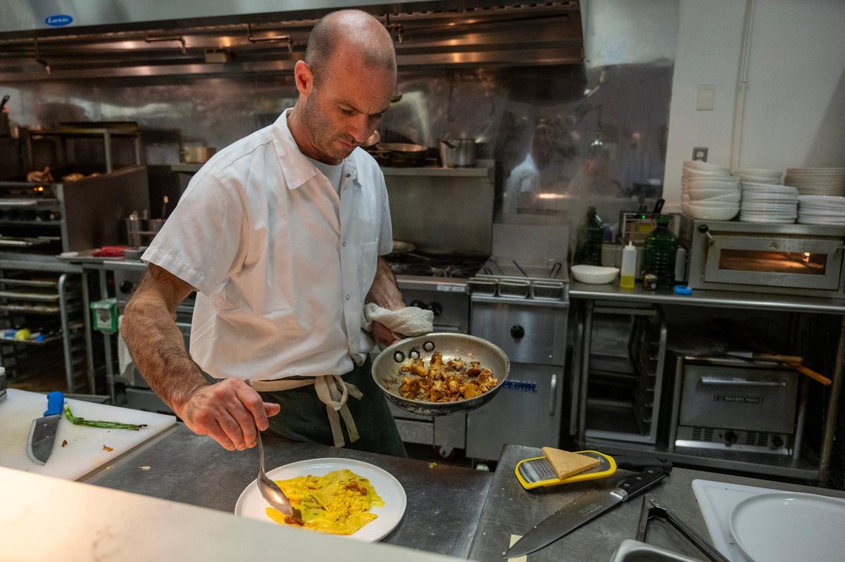 Chef and co-owner Josh Bianchi plates up Fazzoletti with corn crema and chanterelles in the kitchen of his new restaurant, Osteria Bianchi.