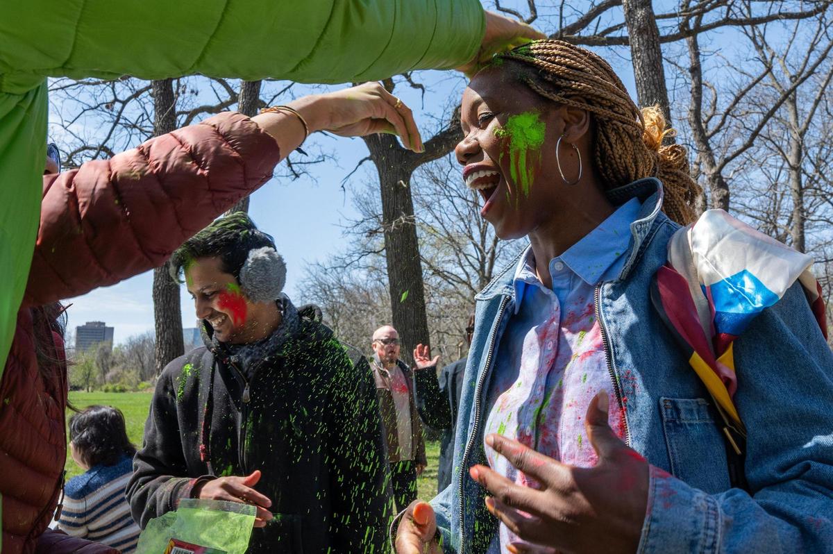Mona Stutzer gets Holi colors spread on her head at a Holi Festival of Colors in Overland Park on Sunday.