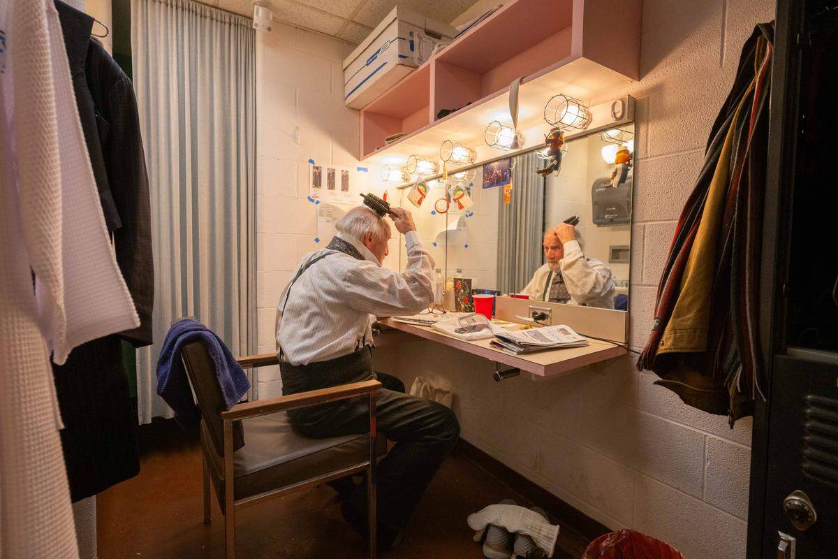 Gary Neal Johnson brushes his hair in preparation to play Scrooge, the main character in Kansas City Repertory Theatre’s rendition of the iconic Charles Dickens story, “A Christmas Carol,” on Friday, Dec. 19. Johnson is retiring following this year’s run of shows, after playing the character for the last 24 years.