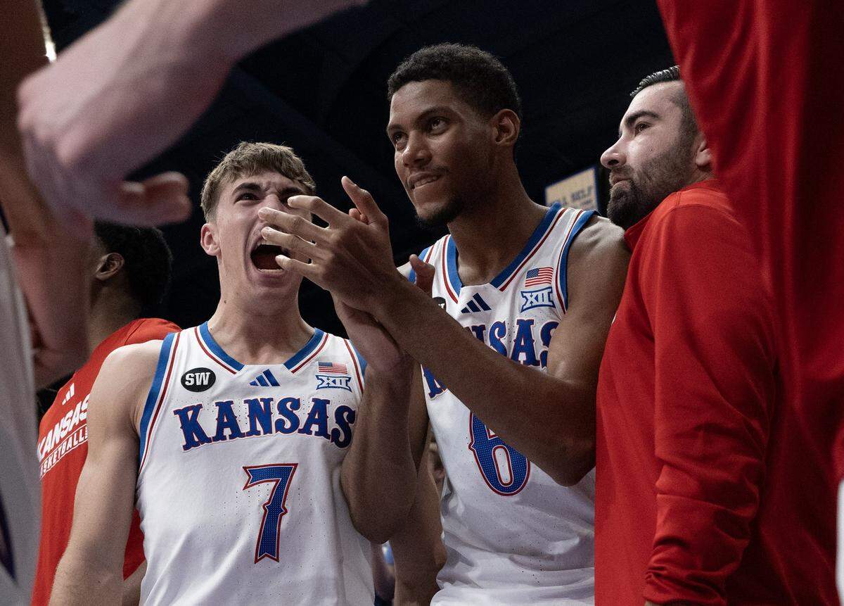 Kansas Jayhawks guard Kohl Rosario (7) and forward Samis Calderon (6) react as the Jayhawks took the lead in overtime at Allen Fieldhouse in Lawrence on Tuesday, Jan. 6, 2025.