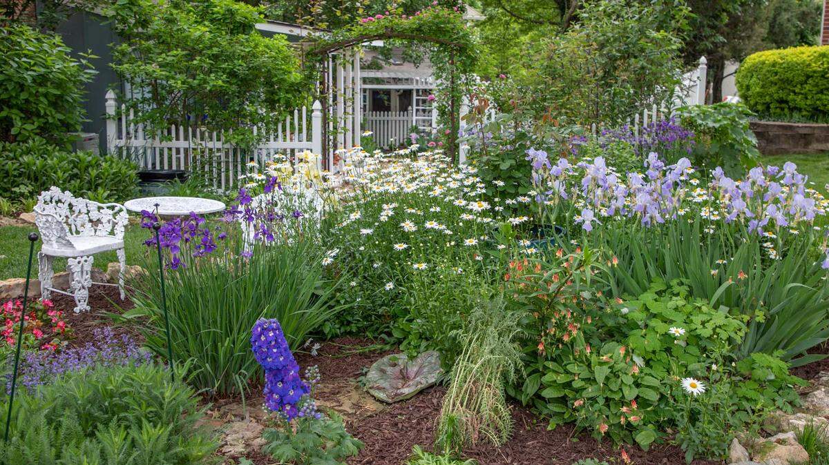 An artful garden with an arbor will delight those heading out on a tour of these Master Gardeners’ homes.
