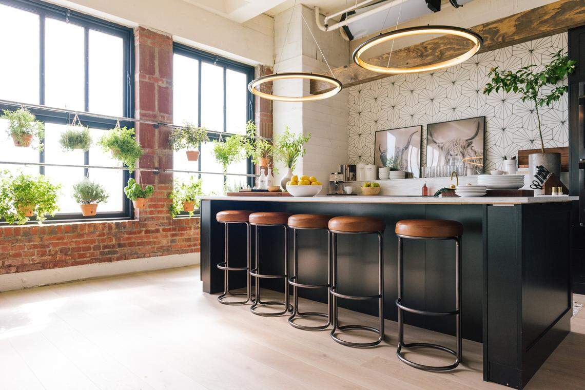 West Elm’s Cora leather counter stools ($249 each) provide stylish seating space in the black and white kitchen of the “Queer Eye” set in downtown Kansas City.