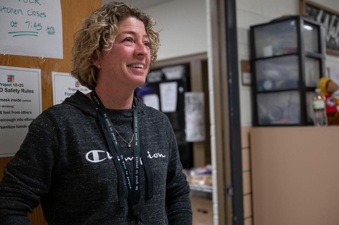 Barb McEver, speaks to a resident before entering the dining facility at Project 1020 winter shelter in Lenexa on Wednesday, March 16, 2022.