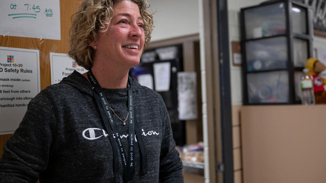Barb McEver, speaks to a resident before entering the dining facility at Project 1020 winter shelter in Lenexa on Wednesday, March 16, 2022.