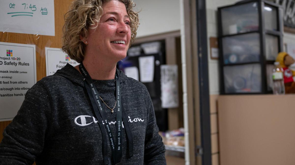 Barb McEver, speaks to a resident before entering the dining facility at Project 1020 winter shelter in Lenexa on Wednesday, March 16, 2022.