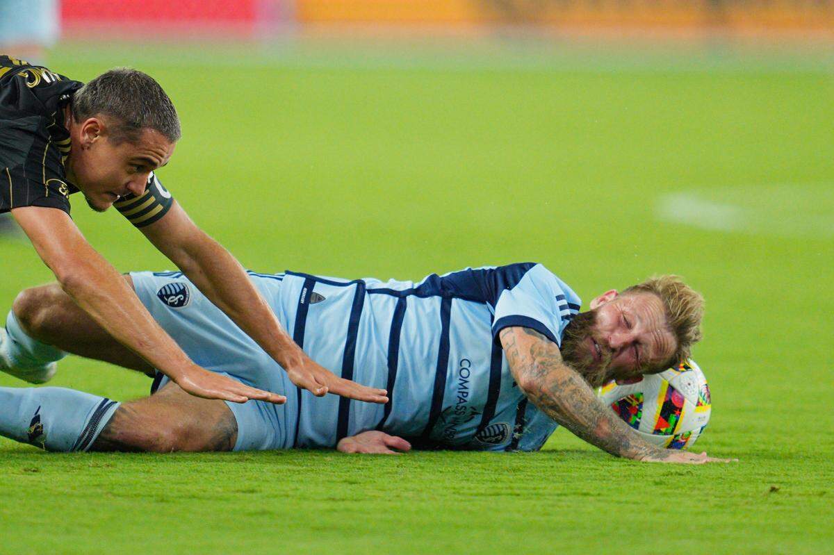 Sporting Kansas City captain Johnny Russell was down on the pitch after being fouled by LAFC forward David Martínez during Saturday night’s MLS match at Children’s Mercy Park in Kansas City, Kan.