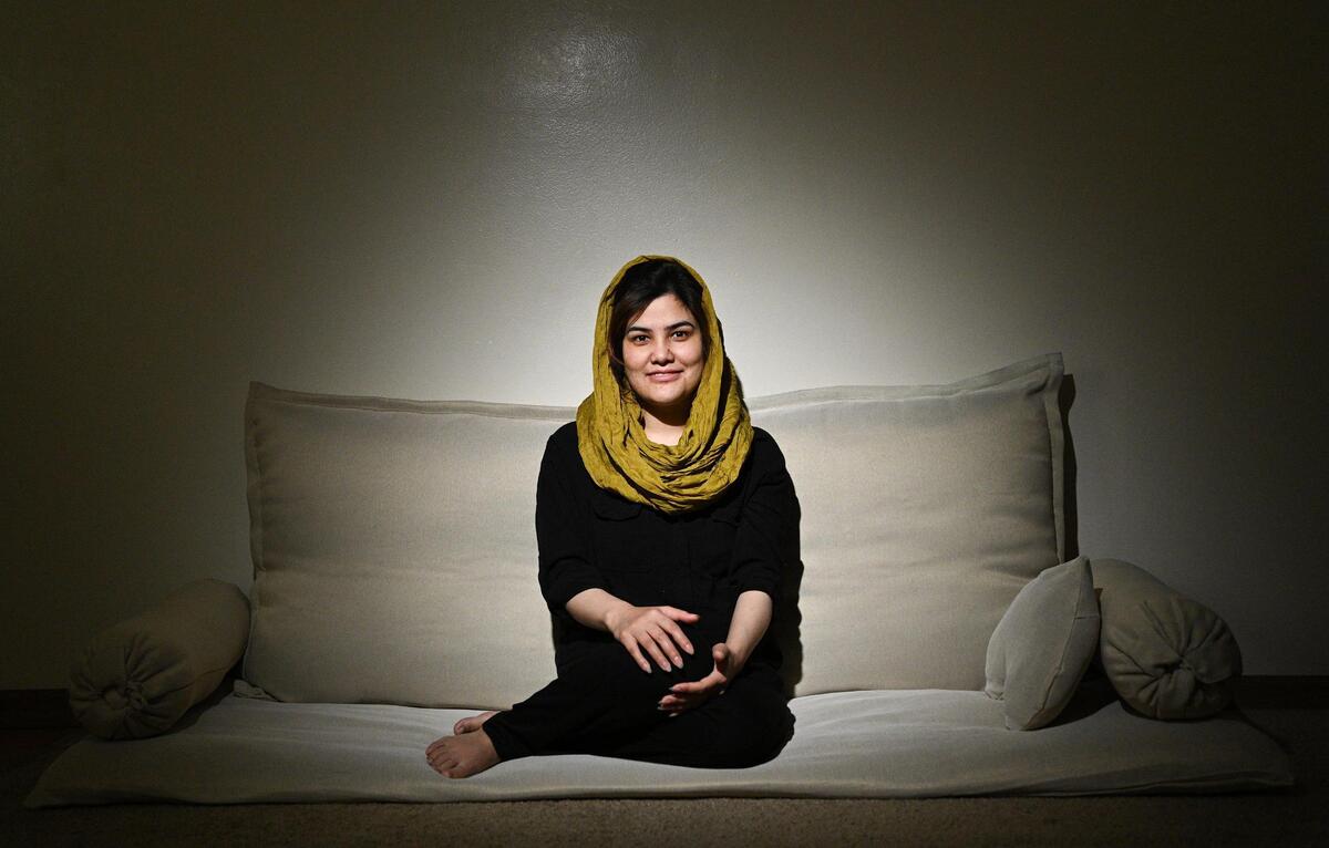Farzana and her husband left Afghanistan shortly after the Taliban took over Kabul. When they arrived in the United States in September, Farzana started sewing Afghan mattresses, like the one she is seated on, called toshaks. She now sells them for $30 and local nonprofits are buying them to present to arriving Afghan refugees.