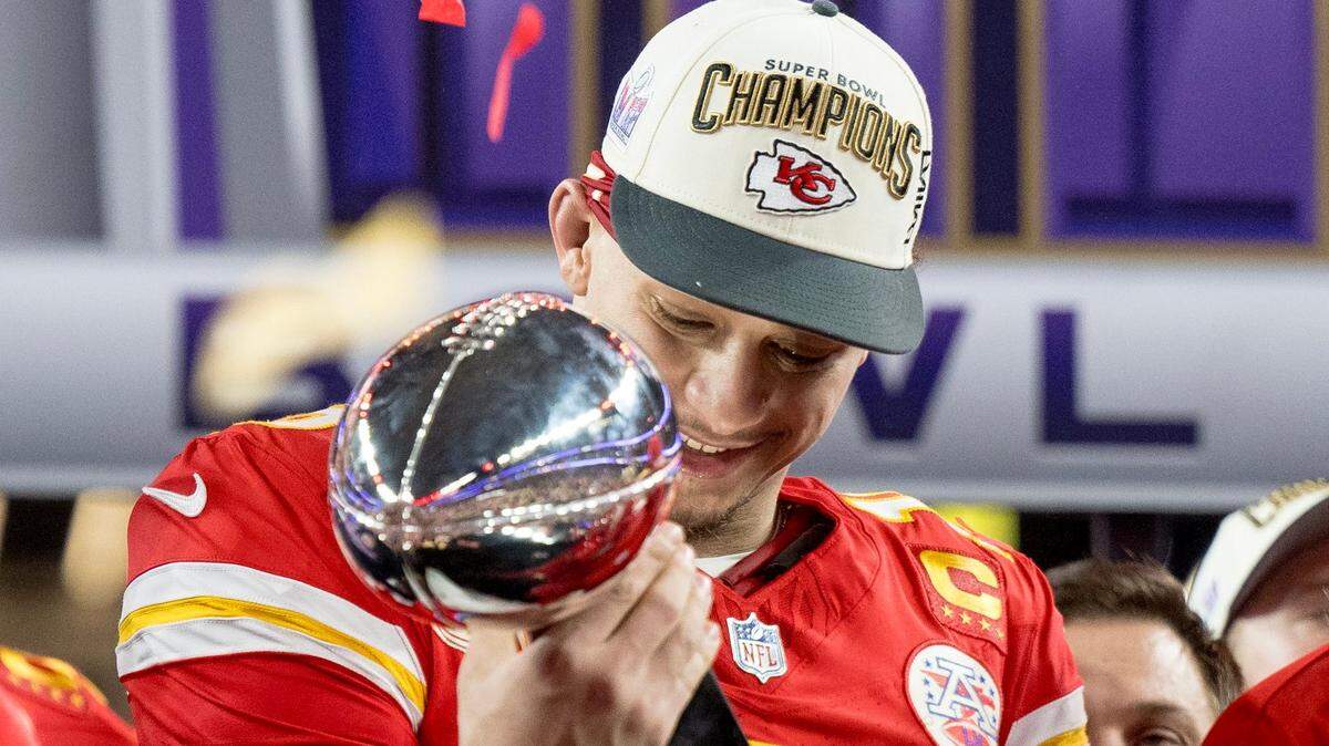 Kansas City Chiefs quarterback Patrick Mahomes (15) admires the Lombardi Trophy after the Chiefs defeated the San Francisco 49ers in overtime 25-22 in Super Bowl LVIII on Sunday, Feb. 11, 2024, in Las Vegas.