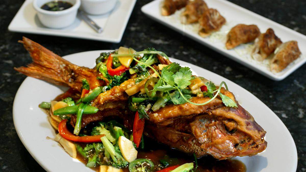 Red Snapper’s whole crispy red snapper served with vegetables and pan-fried pot stickers.