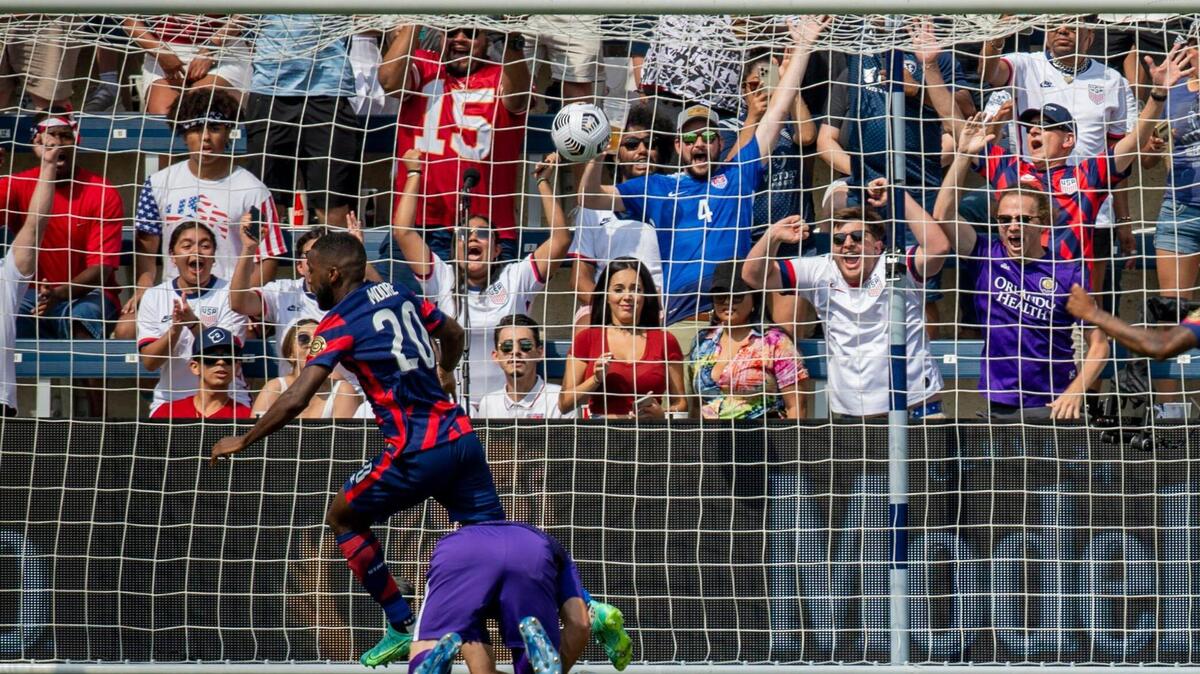 Fans go wild as United States defender Shaq Moore (20) scores the first goal of the game against Canada in the first half of the game, Sunday, July 18, 2021 at Children Mercy’s Field in Kansas City, Kan.