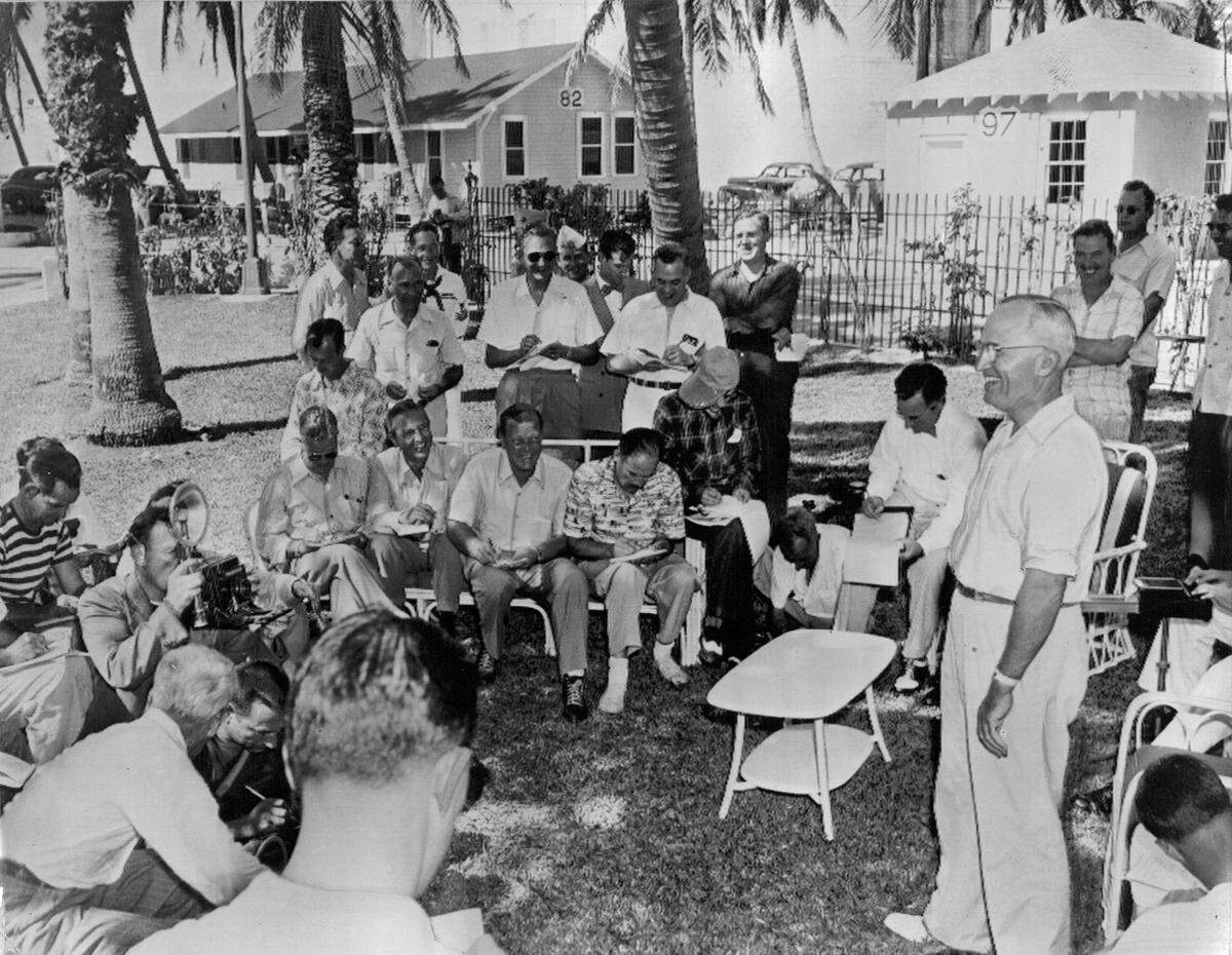 President Harry S. Truman holds his first press conference since his election two weeks earlier at the “Little White House” in Key West, Florida, in 1948. Truman is standing at right.