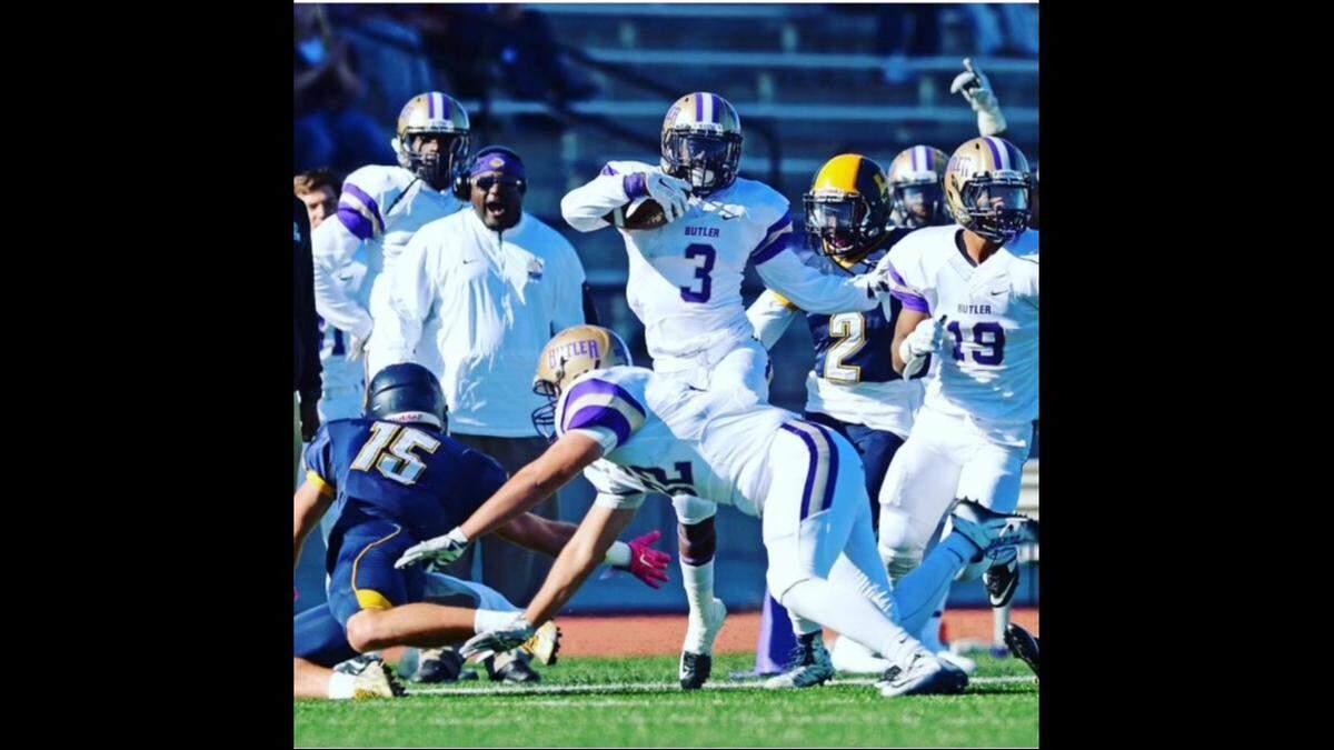 A photo of McKinley Johnson playing football in college.