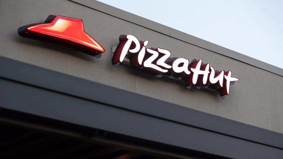 This Dec. 15, 2016, file photo shows a Pizza Hut restaurant in New Orleans. The chain is bringing back The Edge pizza. (AP Photo/Gerald Herbert, File)